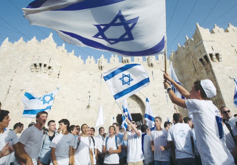Young people wave Israeli flags during the Jerusalem Day march on June 5