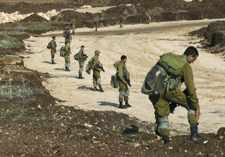 IDF soldiers search for remains of rockets fired from Lebanon in December 2015