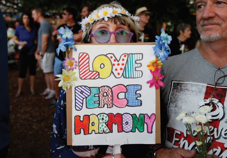 PEOPLE TAKE part in a vigil for the Pulse night club victims following last week’s shooting in Orlando, Florida.