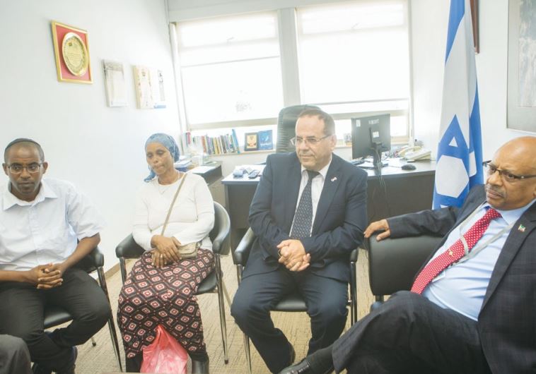 DEPUTY MINISTER for Regional Cooperation Ayoub Kara (center) and Ethiopian Ambassador Helawe Yosef (right) meet with the family of Avraham Mengistu at the Knesset on Monday.