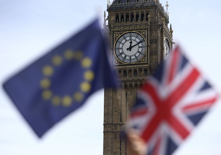 Participants hold a British Union flag and an EU flag during a pro-EU referendum event at Parliament Square in London, Britain June 19, 2016.