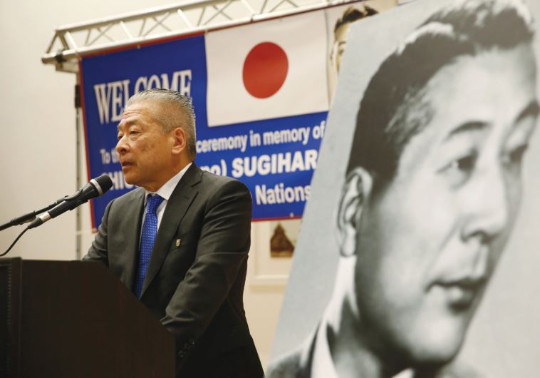 NOBUKI SUGIHARA, son of Japanese diplomat, Chiune Sugihara (in black and white picture), who helped save thousands of Lithuanian Jews in World War II, speaks during a street-naming ceremony in honor of his father in Netanya, earlier this month.