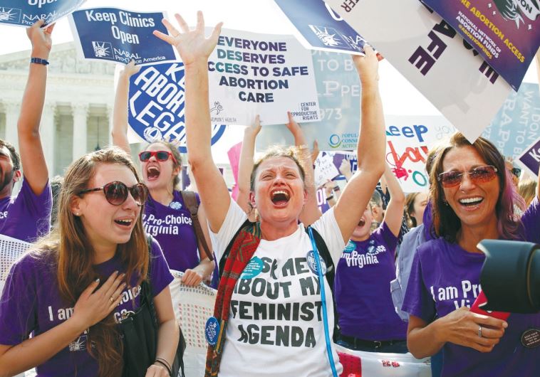 DEMONSTRATORS CELEBRATE at the US Supreme Court in Washington on Monday after the justices struck down a Texas law designed to restrict abortion.