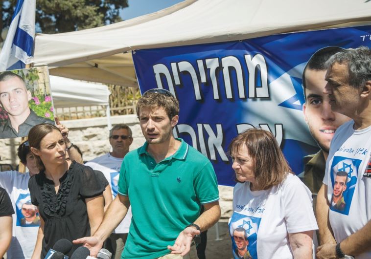 PARENTS OF Lt. Hadar Goldin and St.-Sgt. Oron Shaul, who were killed in the Gaza Strip during 2014’s Operation Protective Edge, hold a protest yesterday outside the Prime Minister’s Residence in Jerusalem.