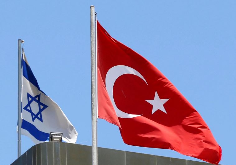 A Turkish flag flutters atop the Turkish embassy as an Israeli flag is seen nearby, in Tel Aviv, Israel June 26, 2016