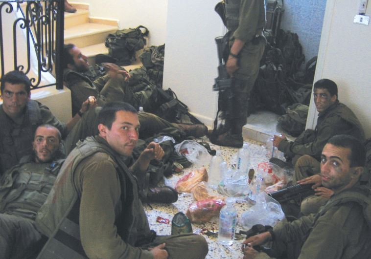 BENYAMIN BEN-ARI (third from left, foreground) and his buddies eat lunch in south Lebanon 10 years ago.