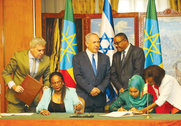 Prime Minister Benjamin Netanyahu and Ethiopian Prime Minister Hailemariam Desalegn preside over the signing of mutual agreements between Israel and Ethiopia, with Israeli Ambassador to Ethiopia Belaynesh Zevadia (seated left)