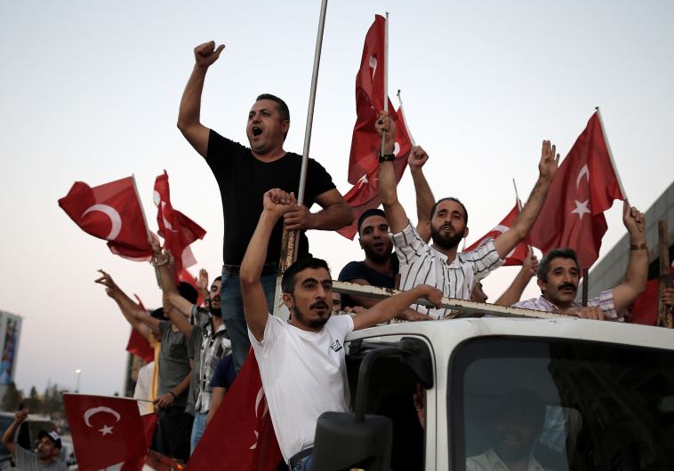 Supporters of Turkish President Tayyip Erdogan shout slogans on the back of a truck during a pro-government demonstration on Taksim square in Istanbul, Turkey, July 16, 2016