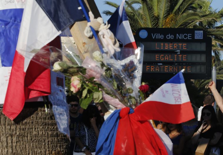 Flowers and flags placed in tribute to victims of the deadly truck attack in Nice, France on Bastille Day 