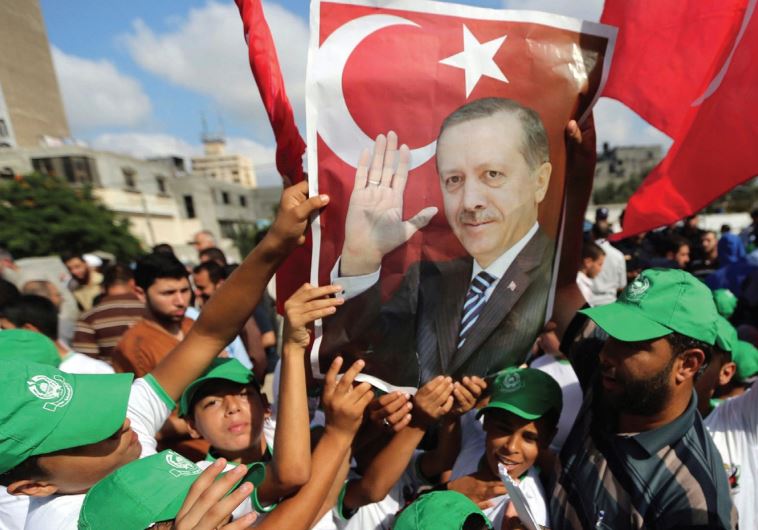 PALESTINIANS HOLD a poster of President Tayyip Erdogan during a demonstration yesterday in Gaza in support of the Turkish government.