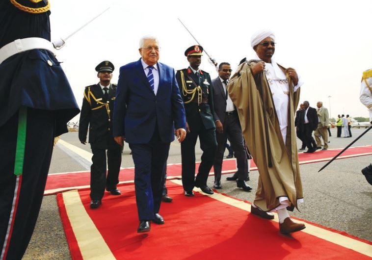SUDANESE PRESIDENT Omer Hassan al-Bashir welcomes PA President Mahmoud Abbas at Khartoum Airport on Tuesday.
