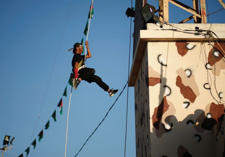 SUMMER FUN in Gaza. A Palestinian rappels down from a building during a Hamas-run summer camp that blends hate and terror education