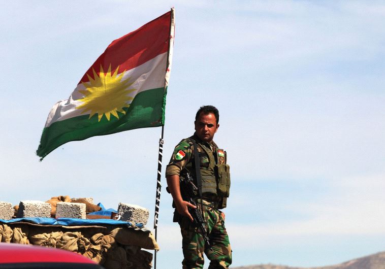 A KURDISH peshmerga soldier stands at a lookout near Bashiqa in northern Iraq