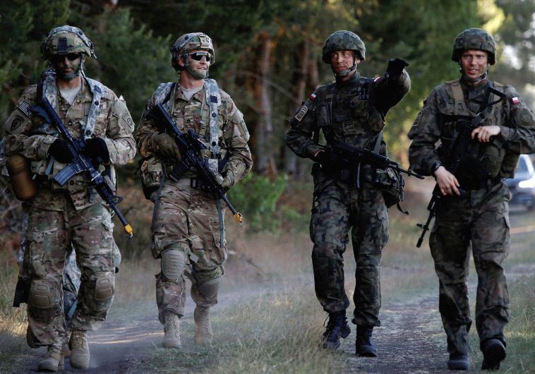 UNDER DONALD TRUMP will they be on their own? Poland’s 6th Airborne Brigade soldiers walk with US 82nd Airborne Division soldiers during the NATO allies’ Anakonda 16 exercise near Torun, Poland, in June