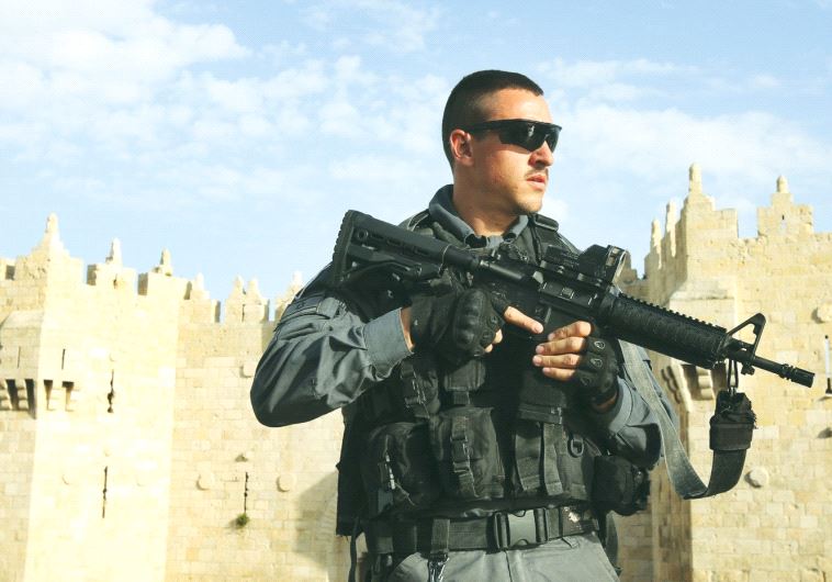 A BORDER POLICE officer patrols the area outside the Damascus Gate of Jerusalem’s Old City recently.