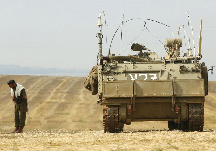 A soldier prays near the border with the Gaza Strip in July 2014