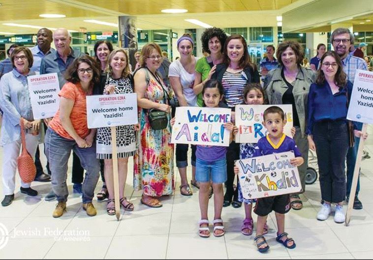 Volunteers with the Jewish Federation of Winnipeg wait at the airport to welcome Yazidi refugees from Iraq