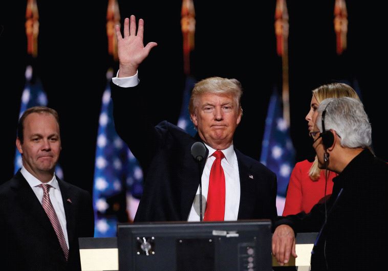 Republican presidential nominee Donald Trump waves during his walk through at the Republican National Convention in Cleveland on July 21
