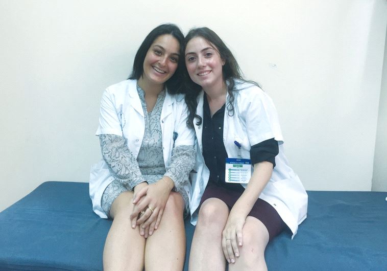 NATIONAL SERVICE VOLUNTEERS Annaelle Dabi (left) and Johanna Arrouas take a break at Sheba Medical Center in Tel Hashomer last week.