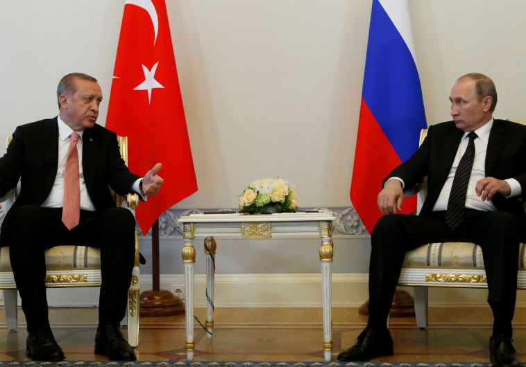 Turkish President Tayyip Erdogan speaks to Russian President Vladimir Putin (R) during their meeting in St. Petersburg, Russia, August 9, 2016