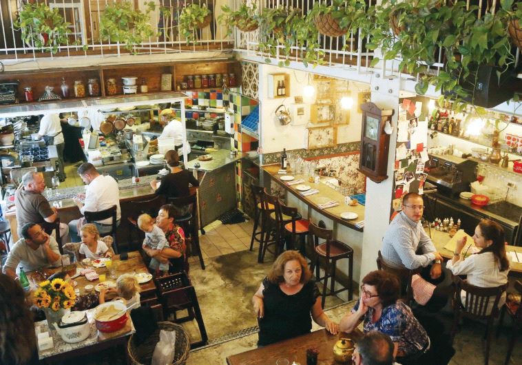 Diners enjoy a meal at the Machneyuda restaurant (non-kosher) in Jerusalem