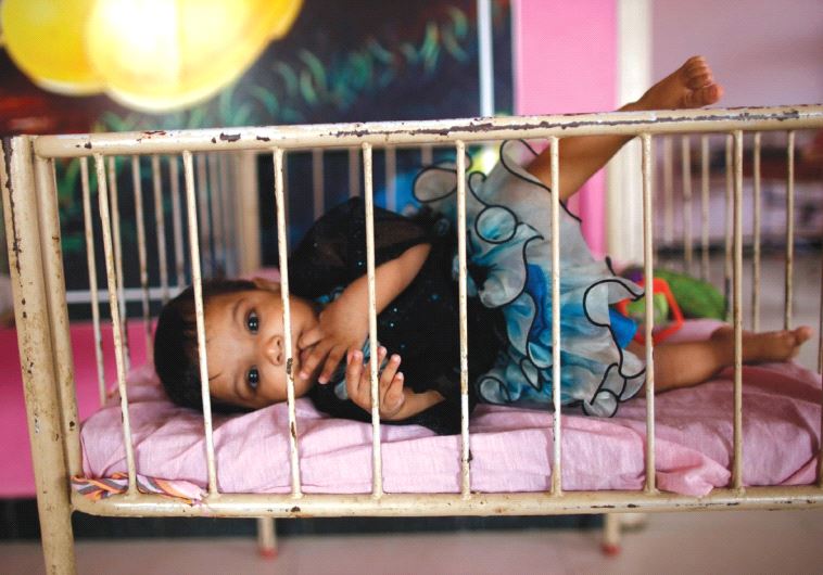 A BABY lies in her crib in this illustrative photo. (