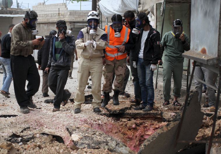 Syrian Civil Defence members wear gas masks near the site of what activists said was a chlorine gas attack in the Idlib countryside [File]