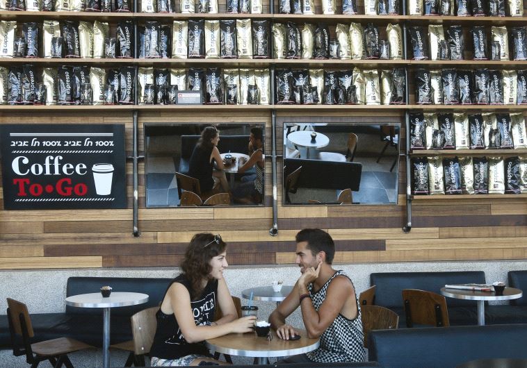 A couple relax at a branch of Aroma in Tel Aviv, one of Israel’s most successful coffee chains
