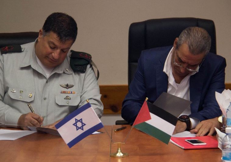 COGAT’s Major General Yoav Mordechai, and the Minister of Civil  Affairs in the Palestinian Authority, Hussein al-Sheikh, sign the memorandum of understanding.