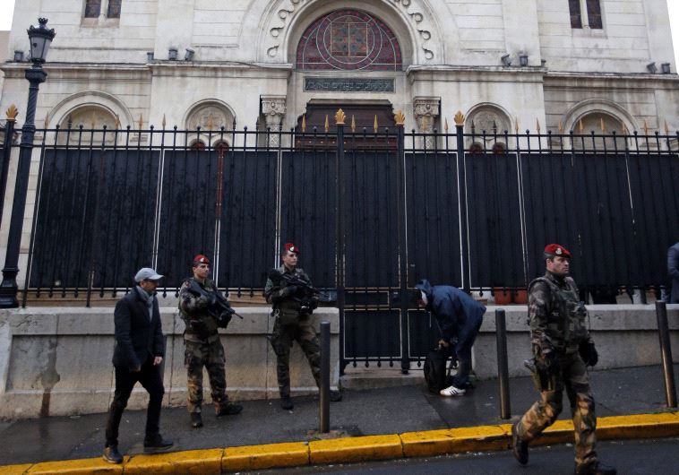 Armed French soldiers stand in front of a Synagogue during a visit of French Interior Minister Bernard Cazeneuve after an attack in front of a Jewish school in Marseille's 9th district, France, January 14, 2016.
