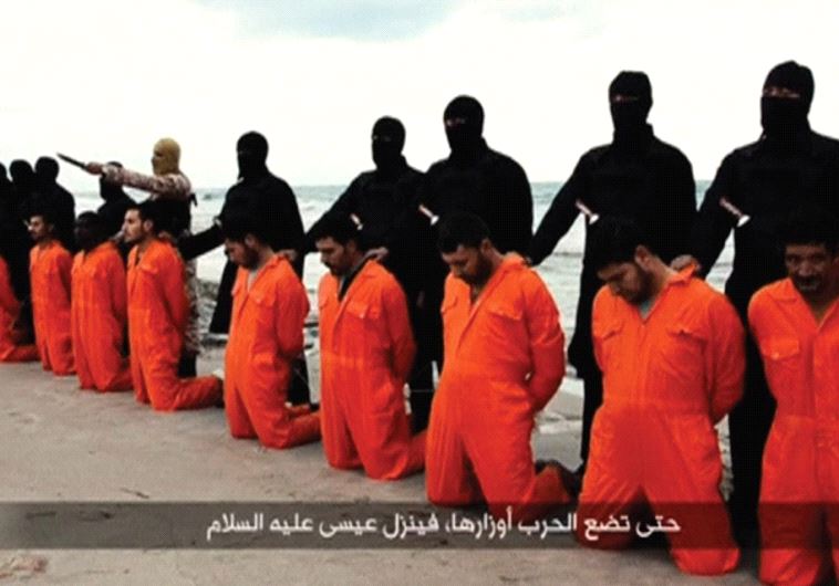 ISIS TERRORISTS pose on a Libyan beach in February 2015 with 21 captured Egyptian Christians they are about to behead