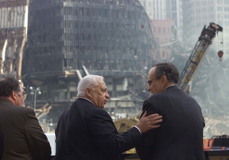 Israeli Prime Minister Ariel Sharon talks with New York City Mayor Rudy Giuliani as they look out over the wreckage of the World Trade Center attacks site in 2001, in New York. 
