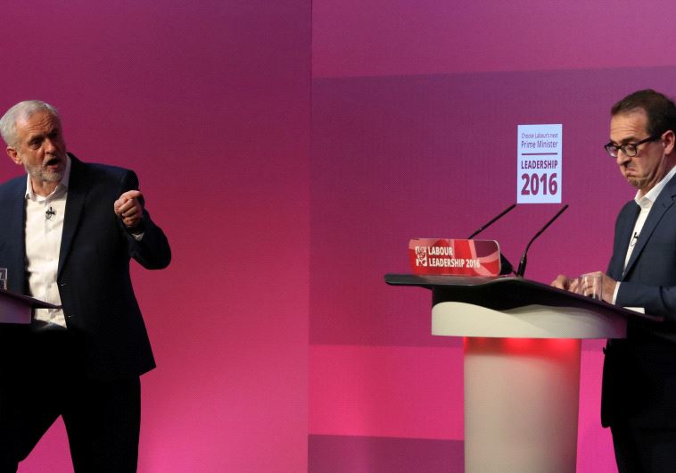 Britain's Labour leader Jeremy Corbyn (L) gestures to Owen Smith during tonight's debate at a Labour Leadership Campaign event in Glasgow, Scotland, August 25, 2016.