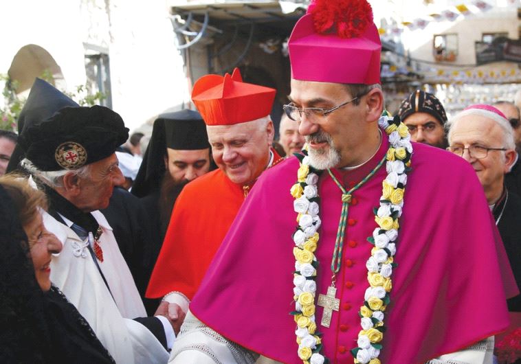 PIERBATTISTA PIZZABALLA shakes hands with a well-wisher in the Old City
