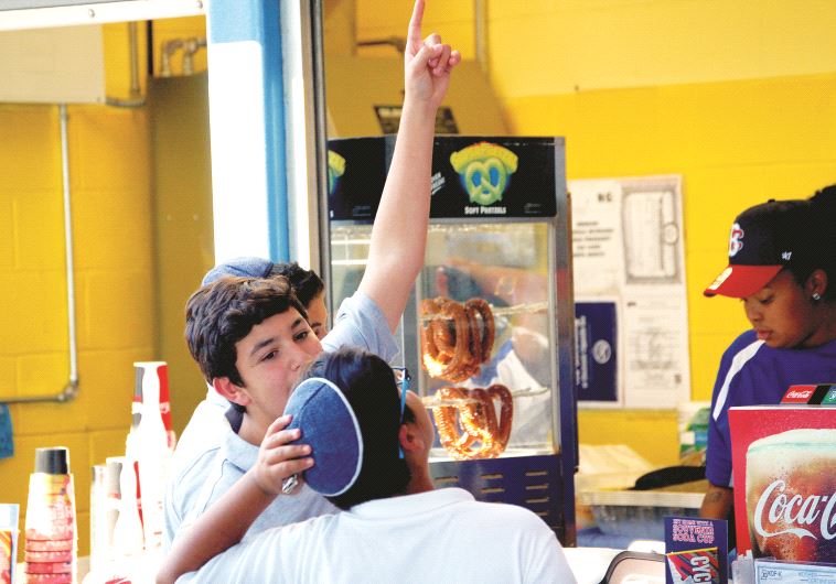 Children at a kosher food stand at the World Baseball Classic Qualifier tournament in New York