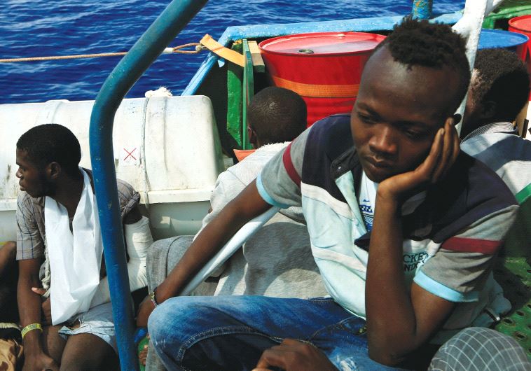 ISSAM IBRAHEEM (right), 13, a migrant from Darfur, sits inside a vessel after he was rescued from an overcrowded dinghy by members of the German NGO Jugend Rettet. The rescue operation took place off the Libyan coast in the Mediterranean Sea last week.