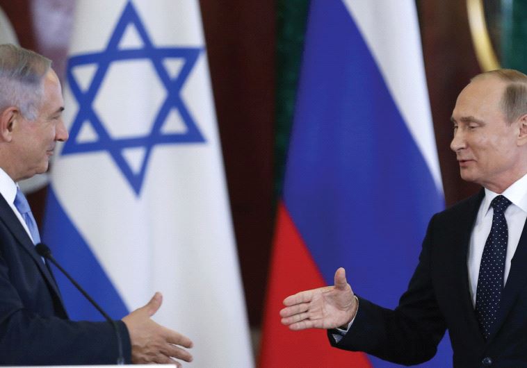 RUSSIAN PRESIDENT Vladimir Putin shakes hands with Prime Minister Benjamin Netanyahu during a news conference at the Kremlin in Moscow