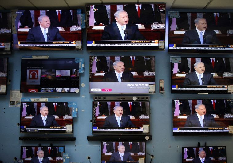 Netanyahu is seen delivering his speech to the U.S. Congress on television screens in an electronics store in a Jerusalem shopping mall March 3, 2015