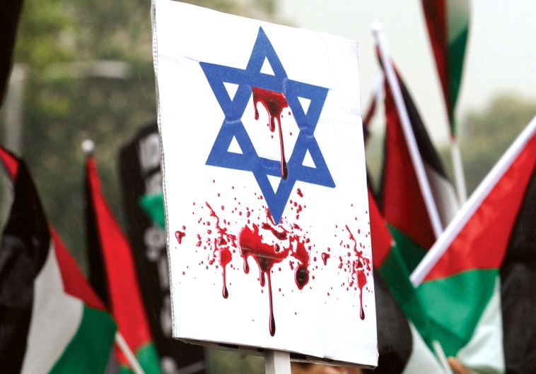 AN ISRAELI FLAG stained with fake blood at a pro-Palestinian rally in London.