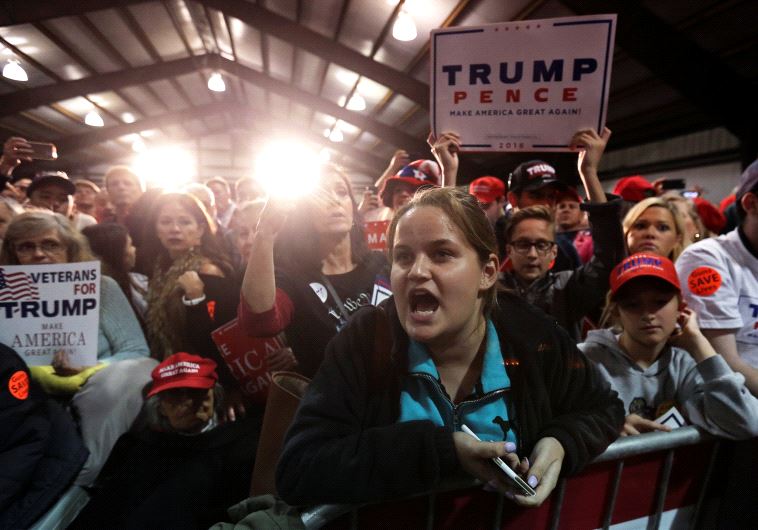 A protester yells as Republican presidential nominee Donald Trump speaks during a campaign rally in Leesburg, Virginia, U.S. November 7, 2016.