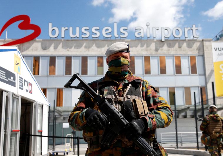 A Belgian soldier stands guard outside the partially reopened departure hall of Zaventem international airport near Brussels, Belgium, May 3, 2016