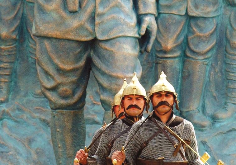 TURKISH TROOPS pose at a World War I memorial near Istanbul.