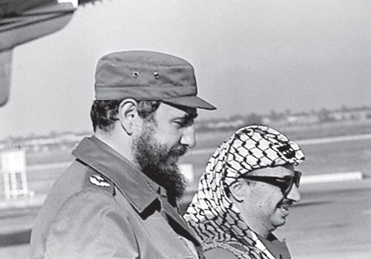 FIDEL CASTRO and Palestinian leader Yasser Arafat stand together at the Havana airport during Arafat’s first visit to Cuba in 1974.
