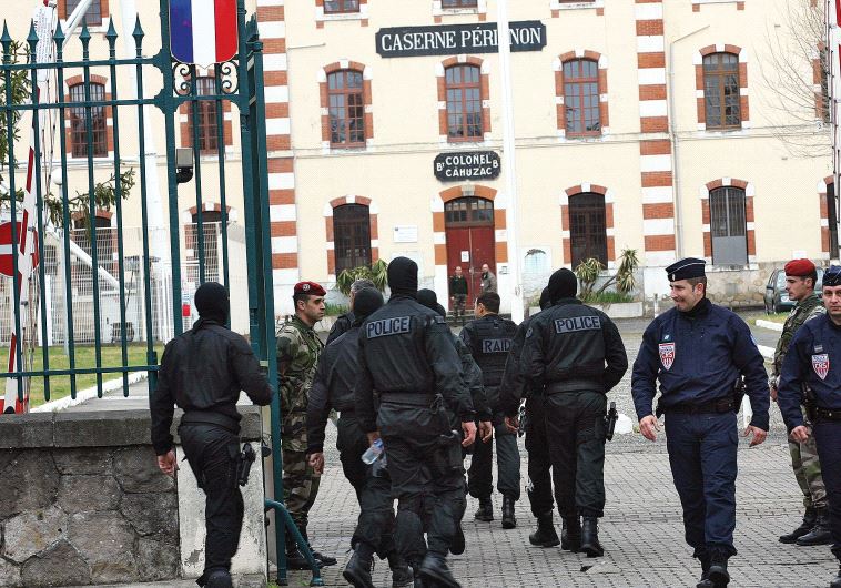 MASKED FRENCH special unit policemen arrive at Perignon barracks after tracking down a terrorist in 2012.