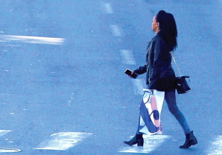 A woman crossing a road (illustrative)