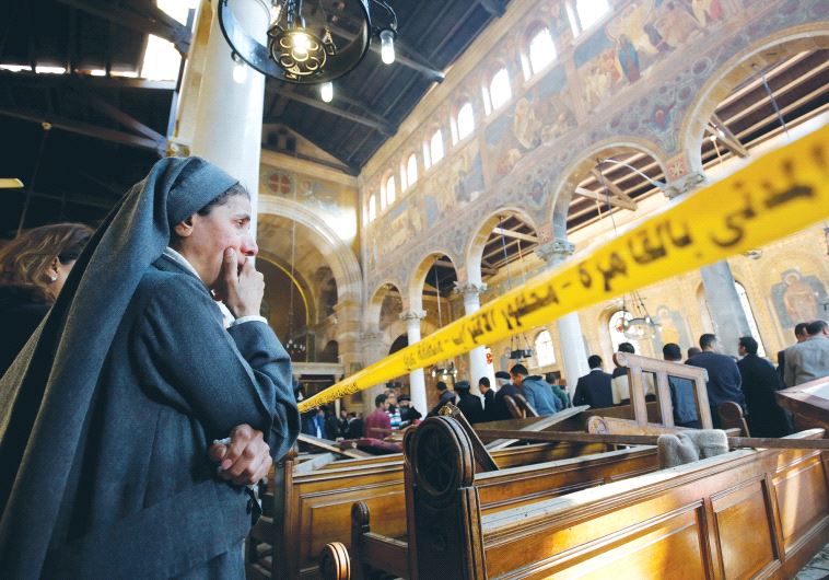 A NUN WEEPS inside Cairo’s St. Marks Coptic Cathedral yesterday, after terrorists killed at least 25 people and wounded 49 during Sunday mass