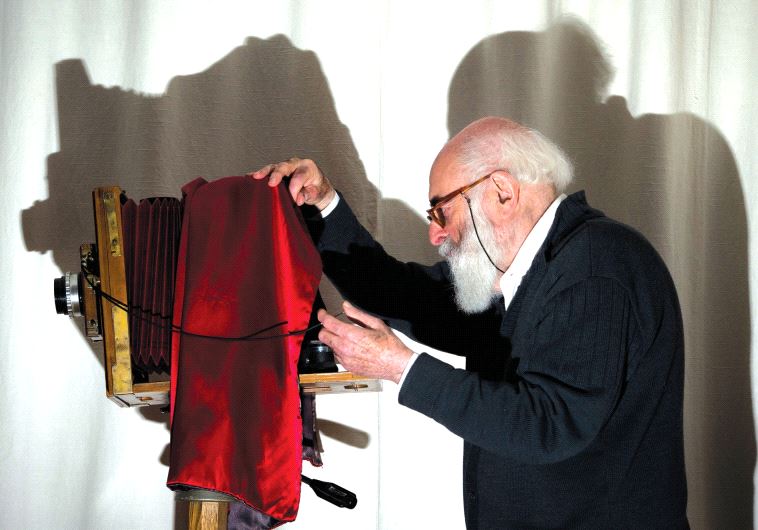Adolfo Kaminsky poses in front of a ‘Lorillon’ view camera at his home in Paris, in 2012