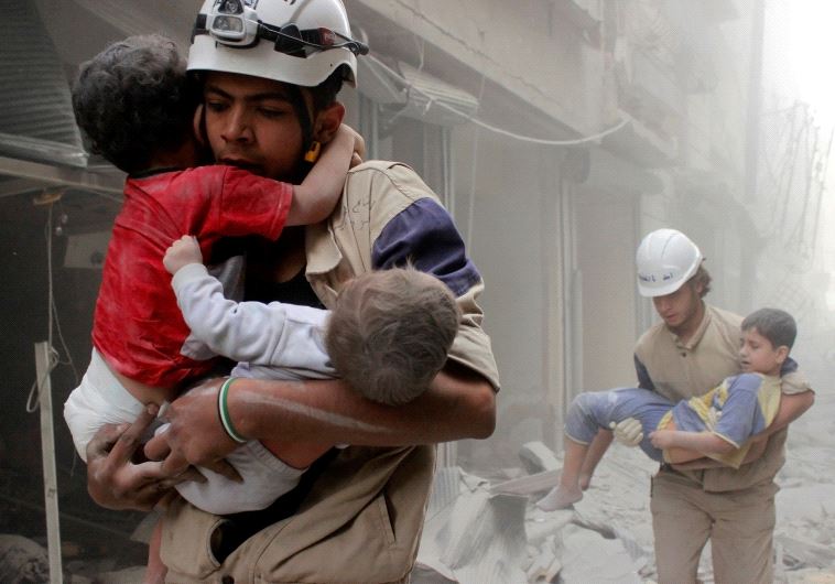 Members of the Civil Defence rescue children after what activists said was an air strike by forces loyal to Syria's President Bashar al-Assad in al-Shaar neighbourhood of Aleppo, Syria June 2, 2014