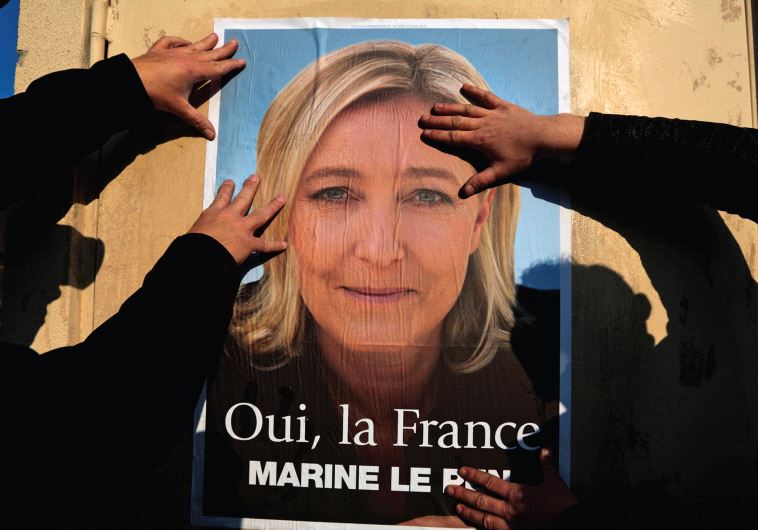 SUPPORTERS OF Marine Le Pen put up a poster earlier this year. There has been a meteoric rise of right-wing movements in Europe, writes the author.