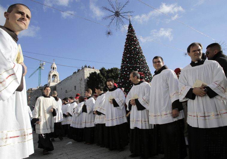 Members of the clergy wait for the arrival of the Latin Patriarch of Jerusalem Fouad Twal during Christmas celebrations in Bethlehem 